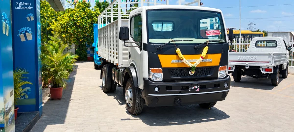 Building Needs' new Ashok Leyland delivery lorry with a flower garland on the front
