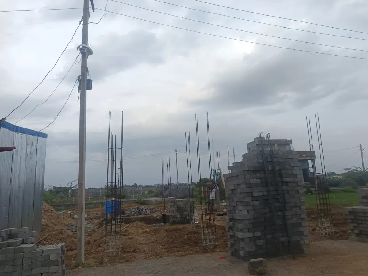 Column reinforcement cages standing on a customer's site with stacks of concrete blocks